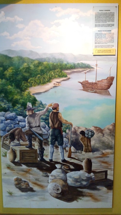 Painting depicting pirates at the Roatán Museum.