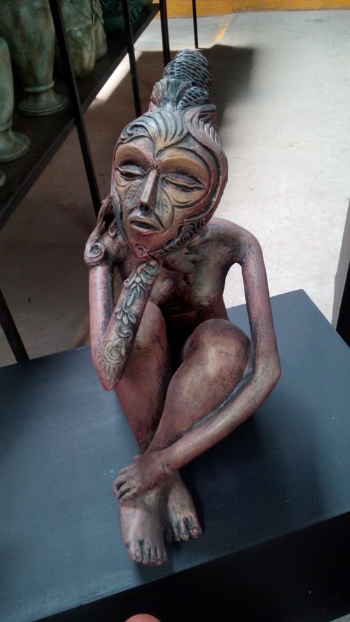 A Cuban artist's sculpture of a seated woman.