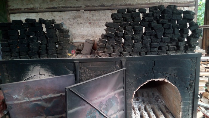 Ovens where wood is burned to heat the main kiln.