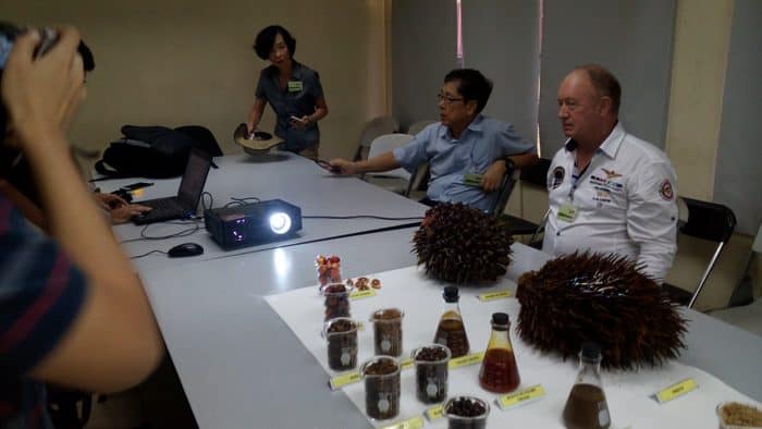 Chinese Ambassador Song Yanbin, with Chamber of Commerce President Harry Bodaan, listens to a presentation at Palma Tica on how palm oil is made.