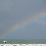rainbow and surfer