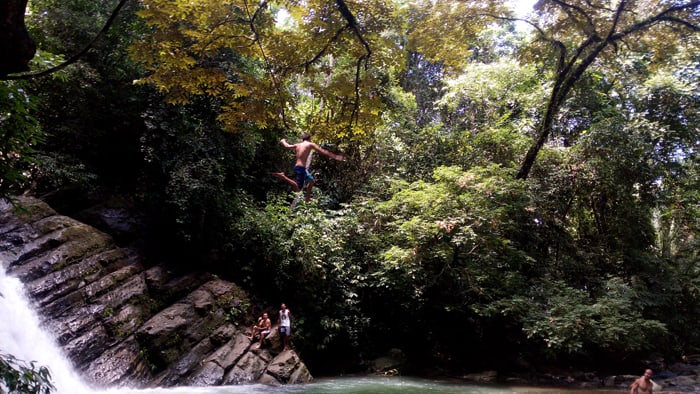 Going airborne on a rope swing at Poza Azul.