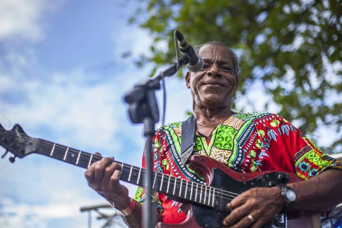 A guitar player singing calypso music at a festival in Puerto Viejo.