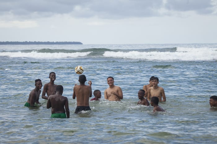 A group of boys play in the water on the shores of Puerto Viejo.