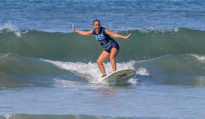 Guiselle Vidal, who doesn't know how to swim, catches her first wave at Playa Guiones.