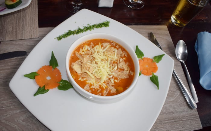 Cream of tomato soup at Rancho Perla, enlivened upon request by tortillas and mozzarella cheese.
