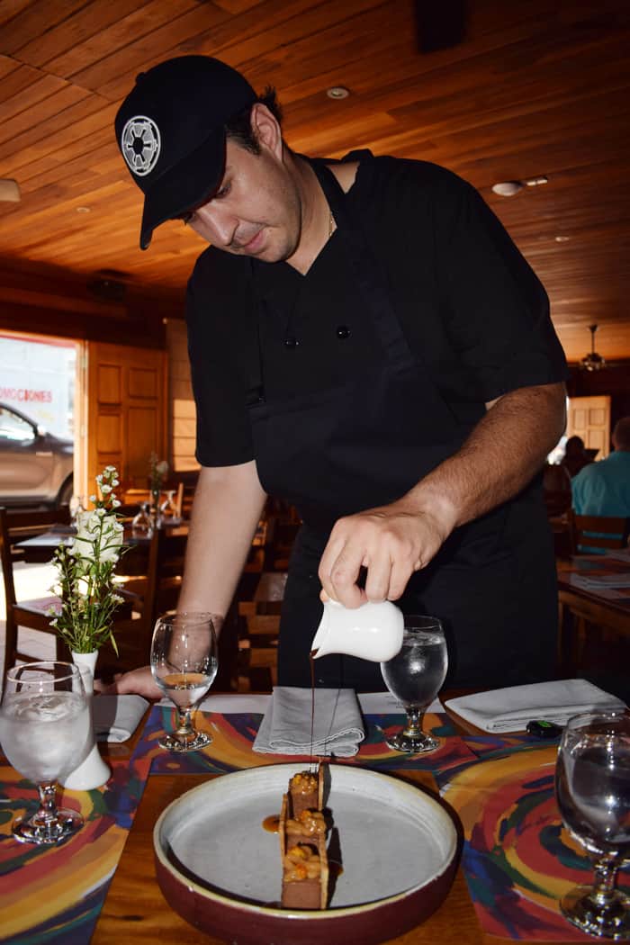Don Rufino head chef Santiago Fernández Benedetto pours chocolate sauce on a decadent mousse.