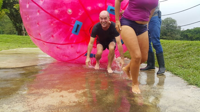 The author and his girlfriend survive their first try at Zorbing — rolling down a hill in a gigantic, flooded plastic ball at Mistico Arenal Hanging Bridges Park.