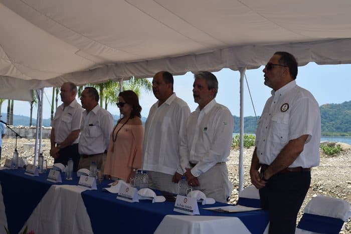 Dignitaries singing the national anthem.