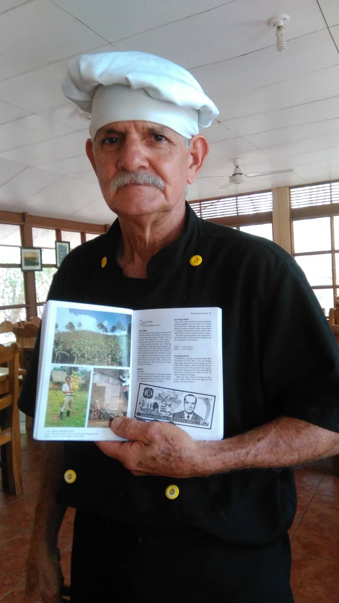 The only time Don Romelio didn't smile was for this picture, where he displayed his photo from the September 1991 edition of Lonely Planet. He is found at the bottom left as a strapping young man holding bananas.