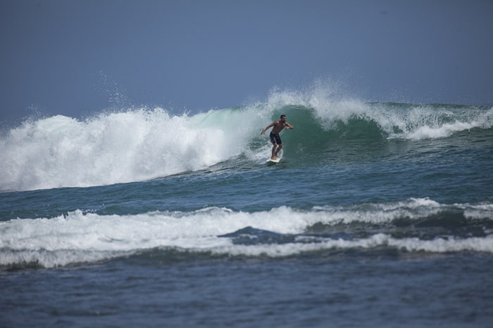 A sufer catches a wave in Puerto Viejo, Costa Rica.