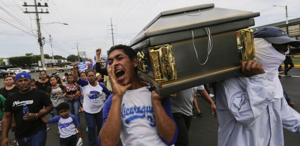 Friends and relatives carry the coffin containing the body of the student Gerald Velazquez, shot dead during clashes with riot police in a church near the National Autonomous University of Nicaragua (UNAN) in Managua,on July 16, 2018.