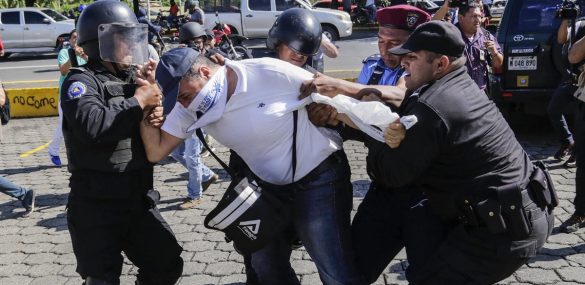 A Nicaraguan man is arrested by riot police during a protest against the government of President Daniel Ortega in Managua, on Oct. 14, 2018.