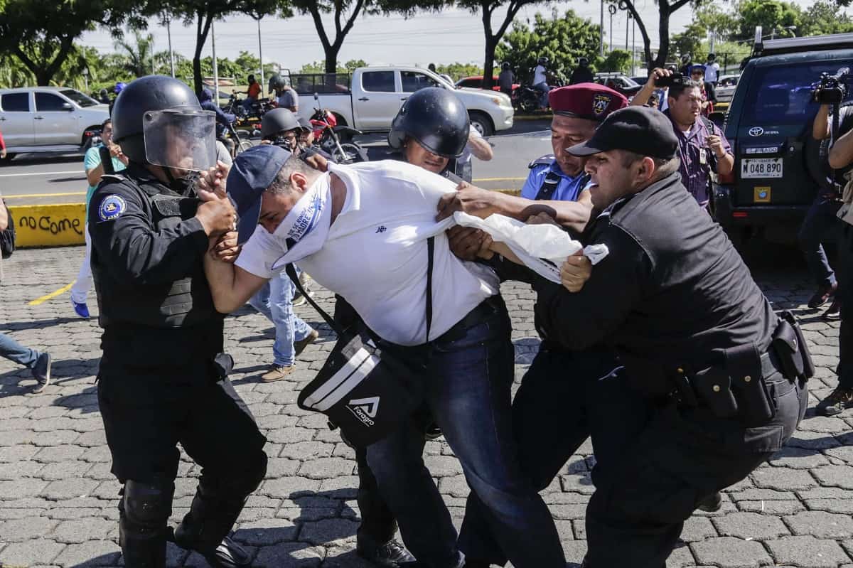 A Nicaraguan man is arrested by riot police during a protest against the government of President Daniel Ortega in Managua, on Oct. 14, 2018.