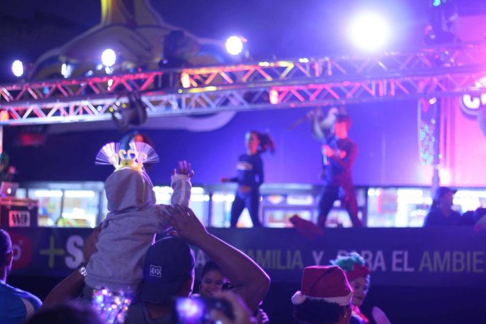 A child watches performers at the Festival de la Luz