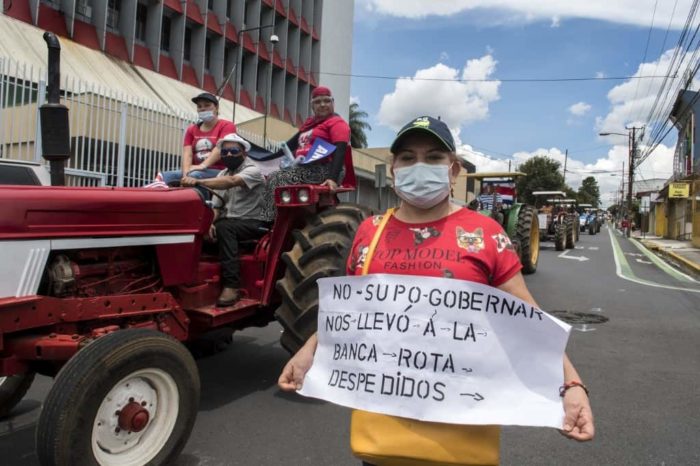 People take part in a protest in rejection of austerity policies promoted by the government to contain public spending amid the COVID-19 pandemic in San Jose, on July 27, 2020.