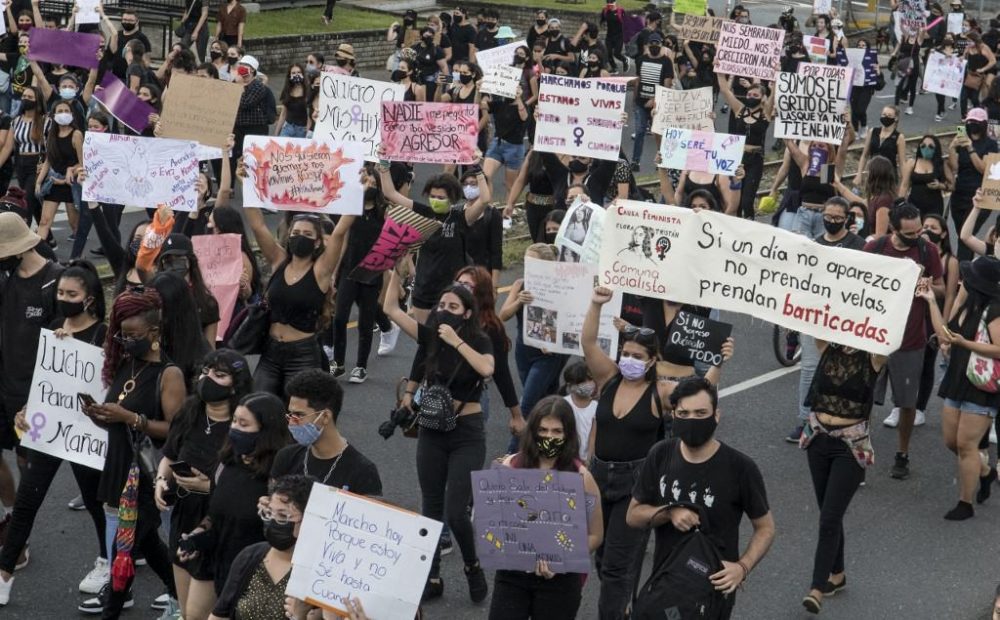 Women protest against femicides during a march also called in rejection of austerity policies promoted by the government to contain public spending amid the COVID-19 novel coronavirus pandemic, in San Jose, on September 6, 2020. 