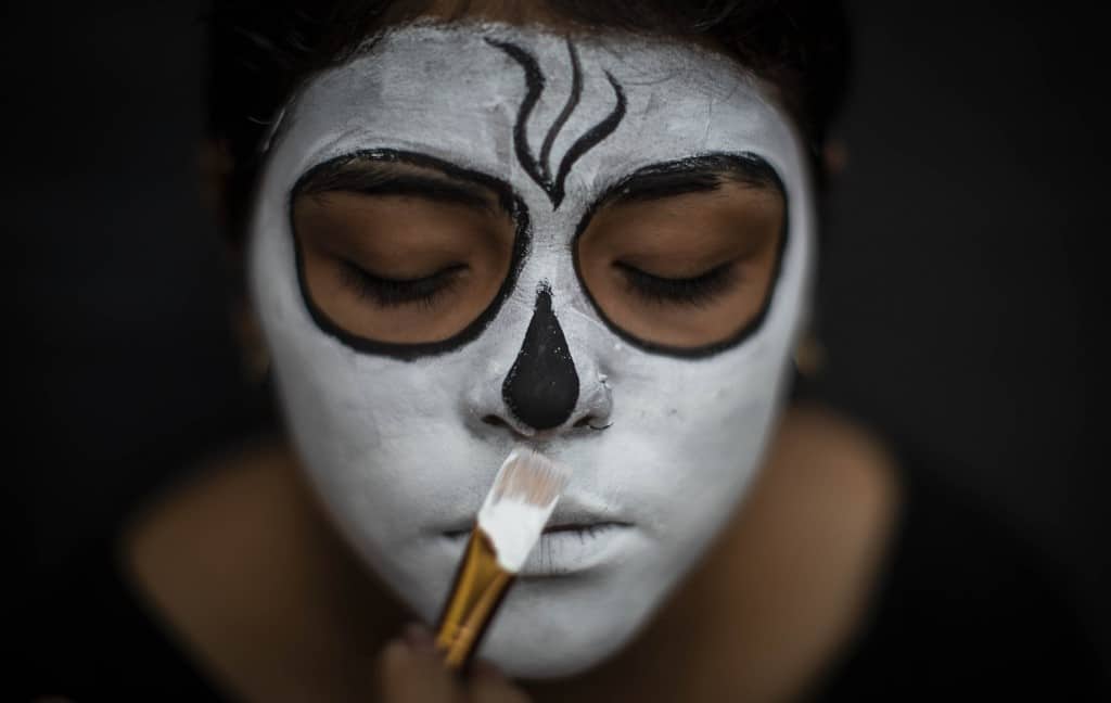 A woman gets some make up before attending to 