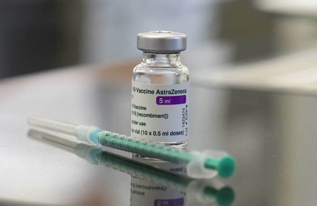 A vial containing the Covid-19 vaccine by AstraZeneca and a syringe are seen on a table in the pharmacy of the vaccination center at the Robert Bosch hospital in Stuttgart, southern Germany.