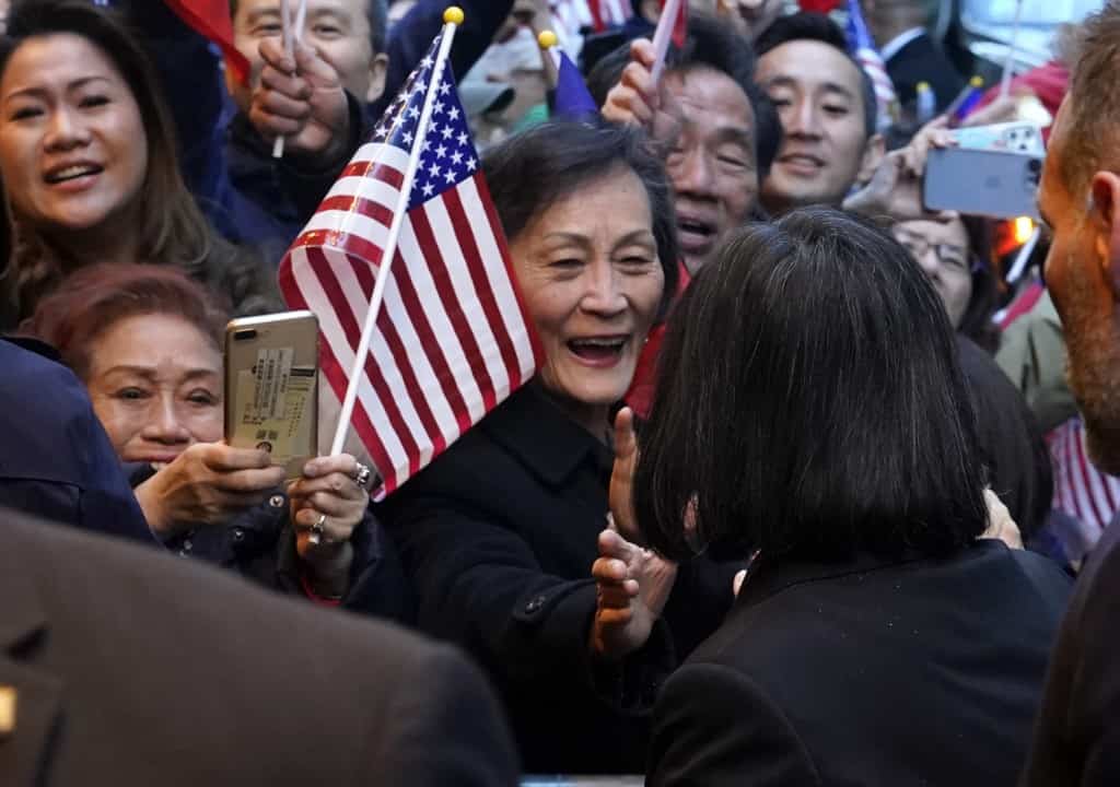 Onlookers react as Taiwan's President Tsai Ing-wen arrives at her hotel in New York City on March 29, 2023, as she begins a ten day international trip.