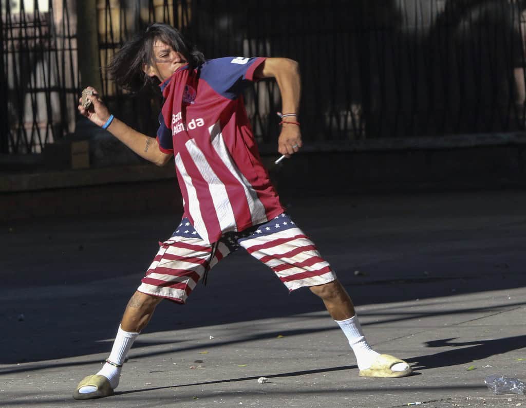 Honduras Student Protestor throws rock