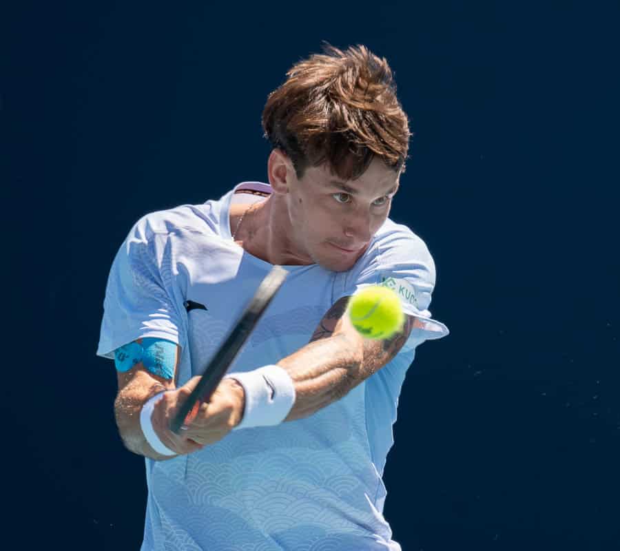 Camilo Ugo Carabelli of Argentina returns a shot at Miami Open 2025