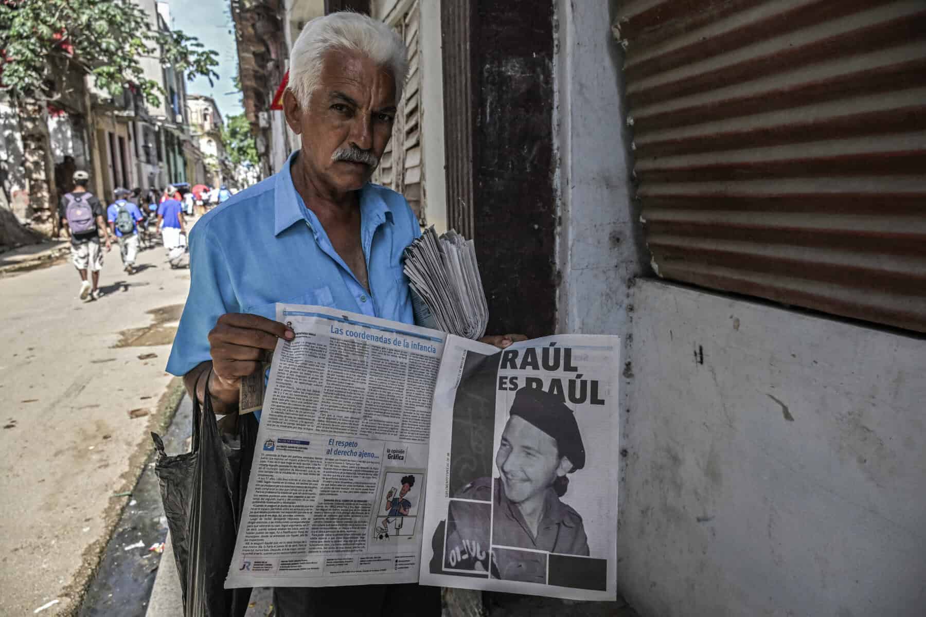 A newspaper vendor displays a picture of former Cuba's President (2008-2018) Raul Castro