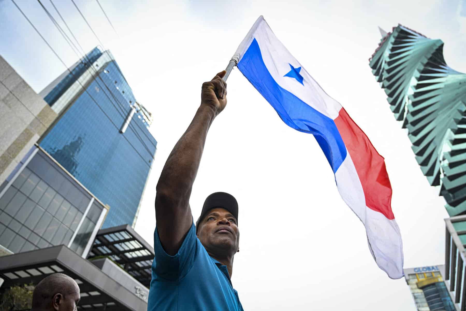Worker in Panama holding Flag of Panama