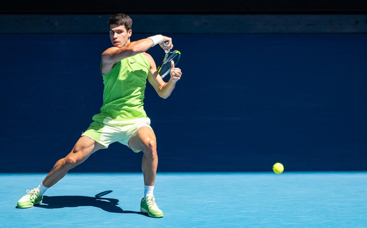 Carlos Alcaraz hits a return at the Australian Open 2026