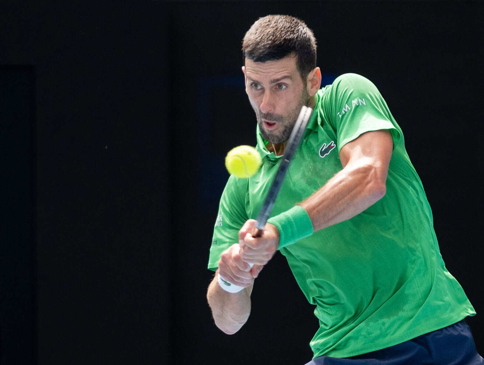 Novak Djokovic hits a two-handed backhand at the Australian Open 2026