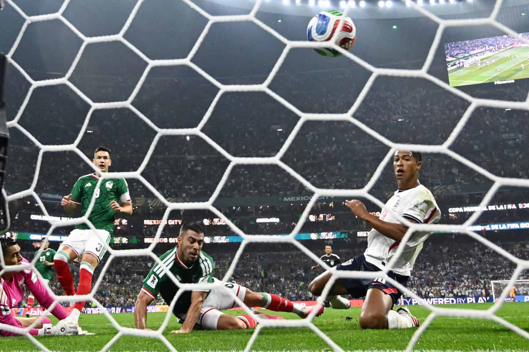 England's midfielder Jude Bellingham (R) scores his team's second goal against Mexico at the 2026 World Cup