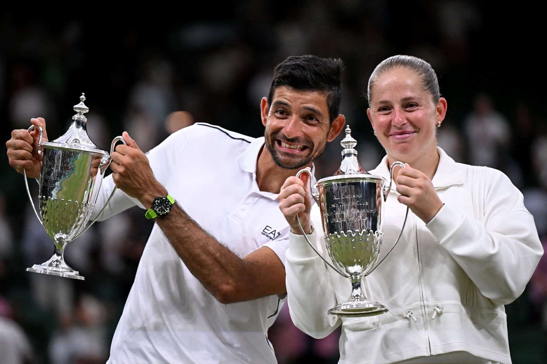 El Salvadoran Marcelo Arévalo and Latvian Jelena Ostapenko hold Wimbledon Mixed Doubles Trophy