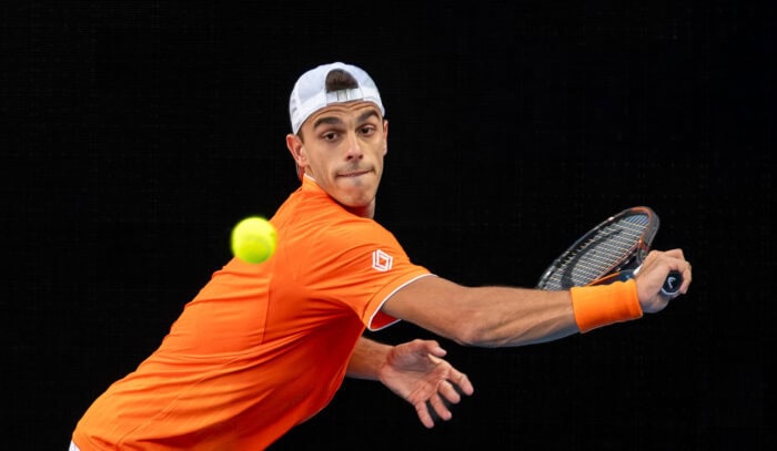 Argentina's Francisco Cerúndolo hits a return at the Australian Open
