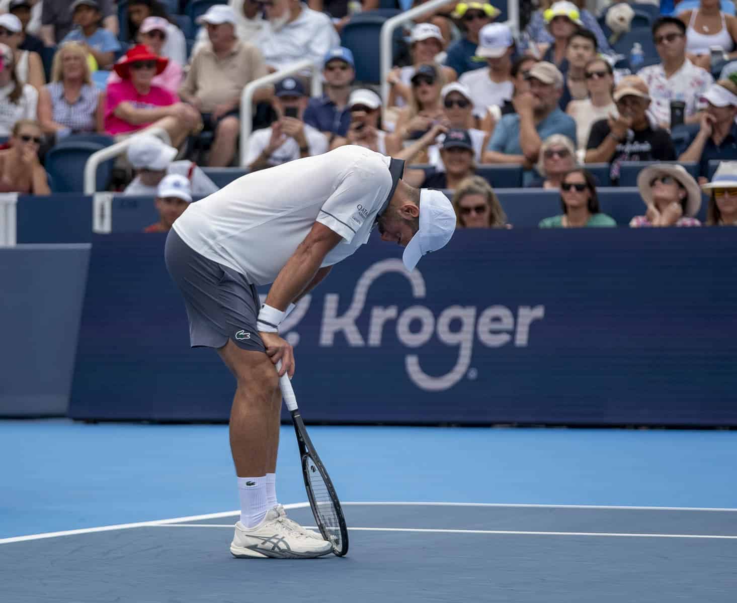 Novak Djokovic bends over during his Cincinnati Open match against Thiago Agustin Tirante